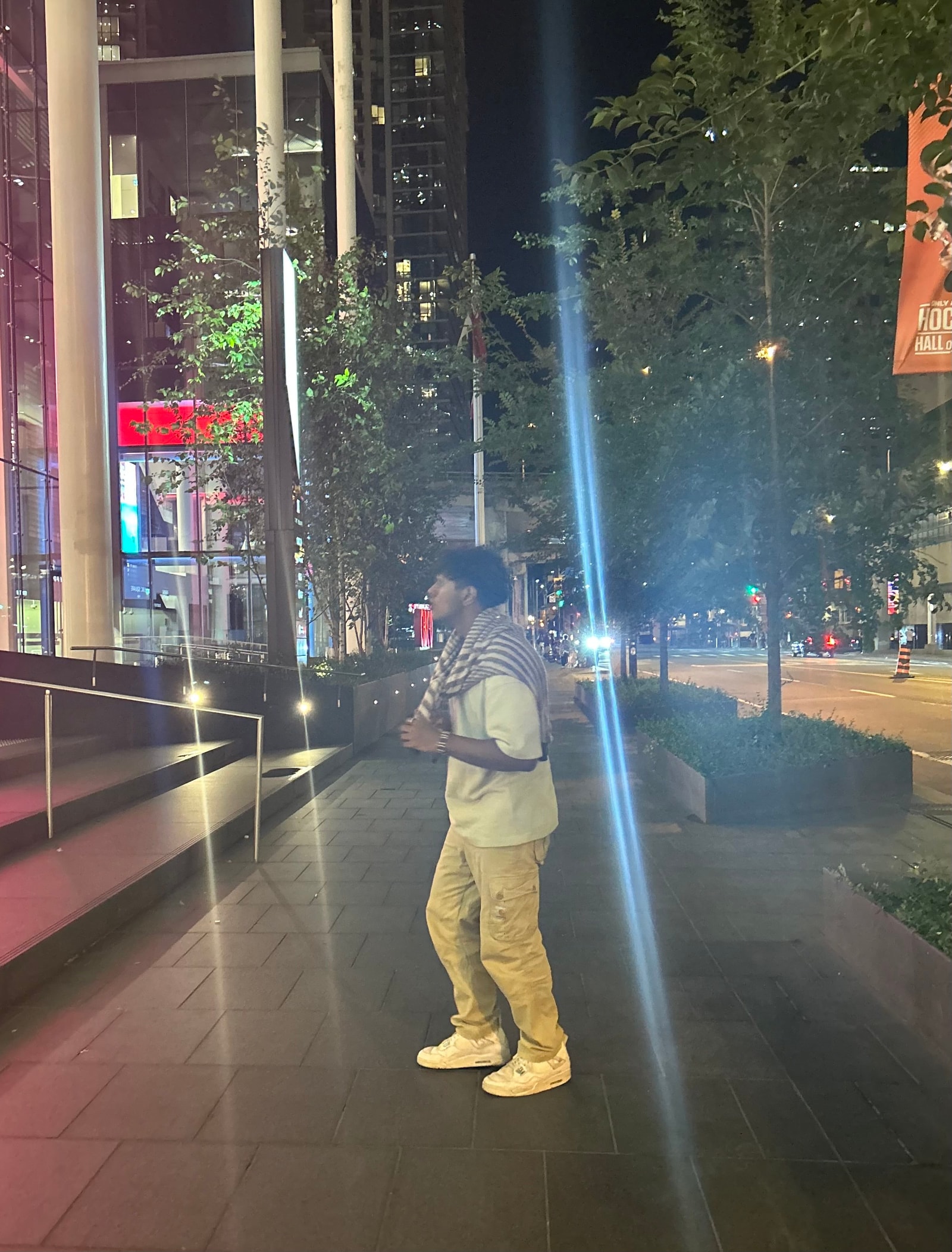 A photo of Vedant on a street in Toronto at night